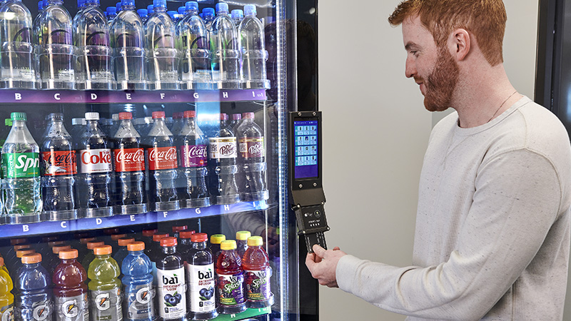 Man pays with a chip card at a Smart Cooler