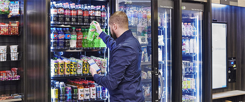 Driver restocks a cooler with soda.