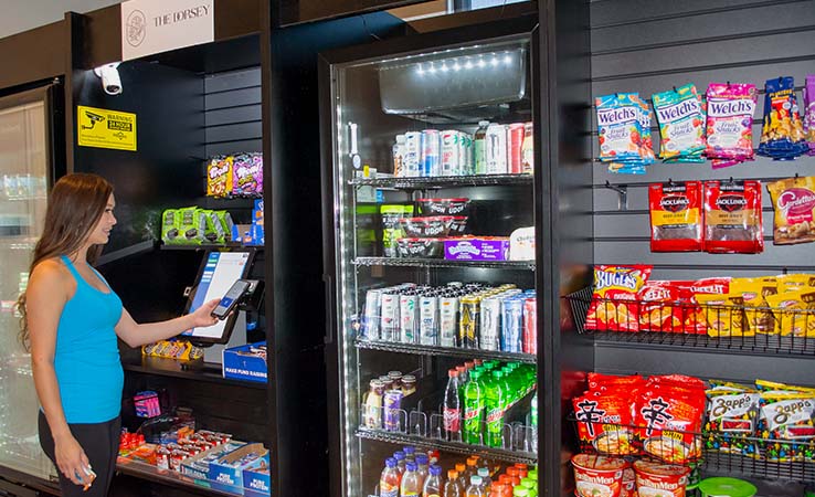 Woman shops at a multifamily building micro market